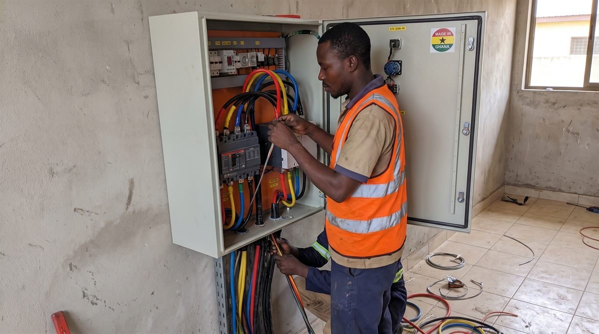 Technician wiring a commercial distribution panel